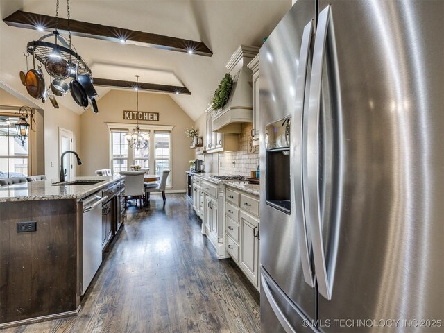 16321 E 48th Pl, Tulsa, OK 74134 - kitchen with a sink, stainless steel appliances, lofted ceiling with beams, white cabinets, and dark wood finished floors