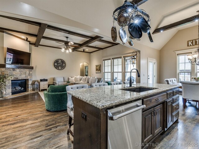 16321 E 48th Pl, Tulsa, OK 74134 - kitchen with a sink, dark brown cabinetry, open floor plan, dishwasher, and ceiling fan with notable chandelier