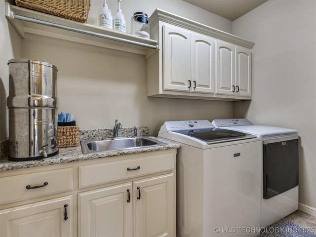 16321 E 48th Pl, Tulsa, OK 74134 - clothes washing area featuring a sink, washer and dryer, cabinet space, and baseboards
