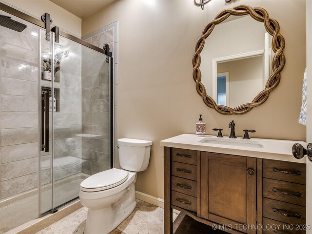 16321 E 48th Pl, Tulsa, OK 74134 - full bathroom with vanity, toilet, a shower stall, and baseboards