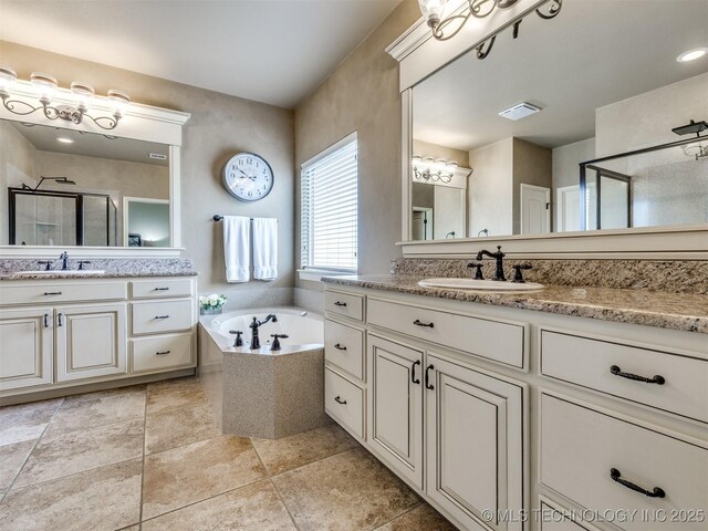 16321 E 48th Pl, Tulsa, OK 74134 - full bath with two vanities, a shower stall, a bath, and a sink