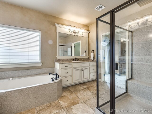 16321 E 48th Pl, Tulsa, OK 74134 - bathroom with a garden tub, vanity, visible vents, and tile patterned flooring