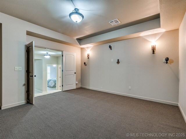 16321 E 48th Pl, Tulsa, OK 74134 - spare room with baseboards, visible vents, a raised ceiling, and dark colored carpet
