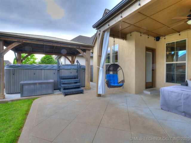 16321 E 48th Pl, Tulsa, OK 74134 - view of patio / terrace with a gazebo, a ceiling fan, and a hot tub