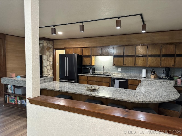 2621 Chuckwa St, Durant, OK 74701 - kitchen featuring high end black fridge, stainless steel microwave, a sink, dishwashing machine, and a peninsula