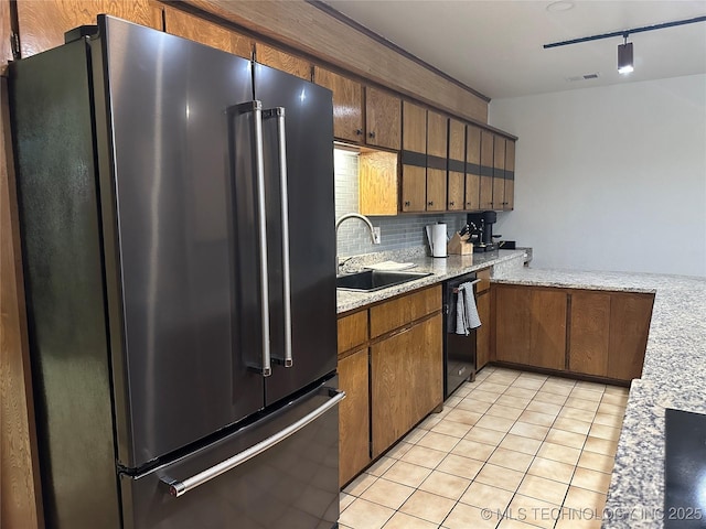 2621 Chuckwa St, Durant, OK 74701 - kitchen with high end fridge, a sink, black dishwasher, light tile patterned floors, and decorative backsplash