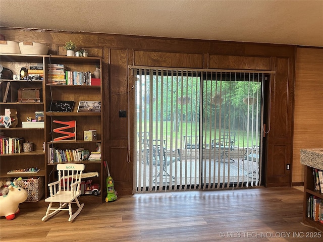 2621 Chuckwa St, Durant, OK 74701 - living area featuring wood finished floors and wooden walls
