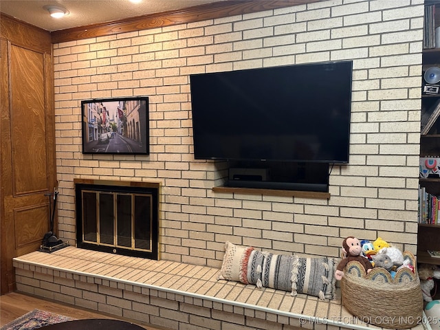 2621 Chuckwa St, Durant, OK 74701 - detailed view of a brick fireplace, crown molding, and wood finished floors
