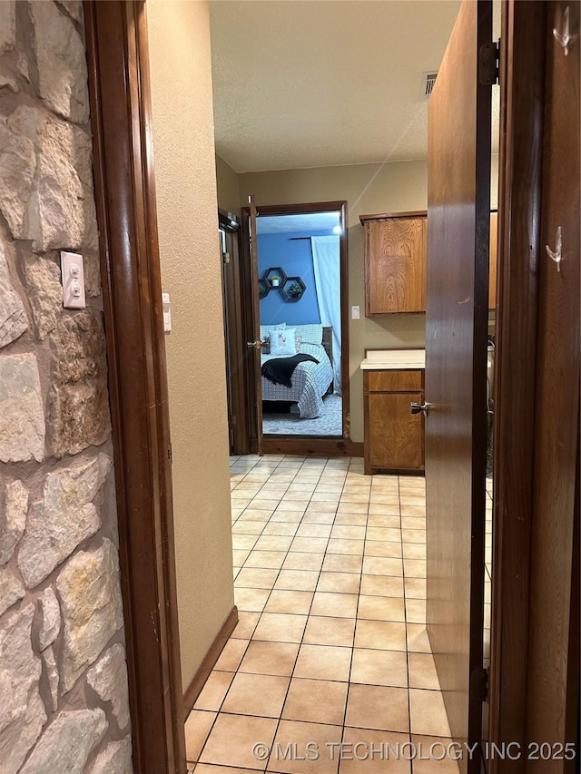 2621 Chuckwa St, Durant, OK 74701 - corridor featuring light tile patterned floors