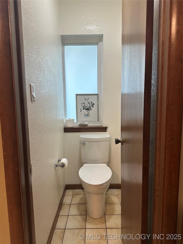 2621 Chuckwa St, Durant, OK 74701 - bathroom with baseboards, toilet, tile patterned floors, and a textured wall