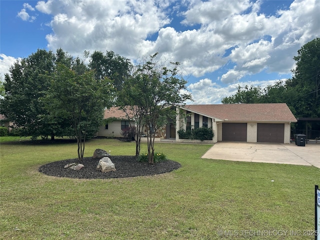 2621 Chuckwa St, Durant, OK 74701 - view of front of house with a front yard, an attached garage, driveway, and brick siding