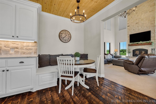 5393 W 184th St S, Mounds, OK 74047 - dining space with wooden ceiling, a chandelier, ornamental molding, dark wood-style flooring, and a fireplace