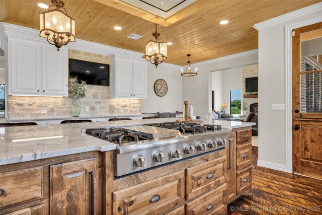 5393 W 184th St S, Mounds, OK 74047 - kitchen featuring stainless steel gas cooktop, light stone countertops, a notable chandelier, wood ceiling, and dark wood finished floors
