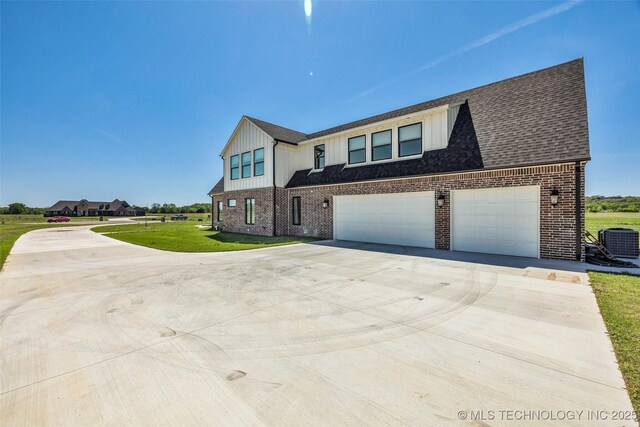 5393 W 184th St S, Mounds, OK 74047 - view of front facade with concrete driveway, central AC, brick siding, and board and batten siding