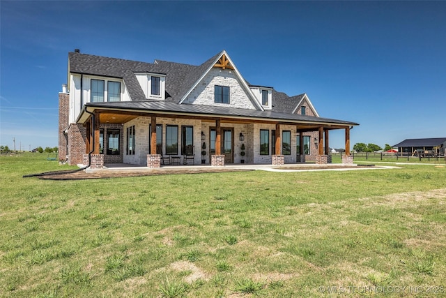 5393 W 184th St S, Mounds, OK 74047 - rear view of property with a standing seam roof, metal roof, roof with shingles, a lawn, and brick siding