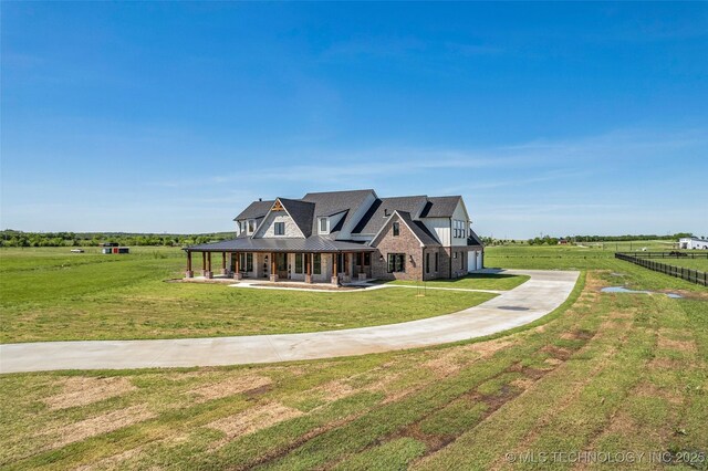 5393 W 184th St S, Mounds, OK 74047 - view of front of house with driveway, a standing seam roof, a porch, and a front lawn