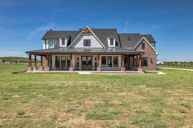 5393 W 184th St S, Mounds, OK 74047 - back of property featuring a standing seam roof, brick siding, a shingled roof, metal roof, and a lawn