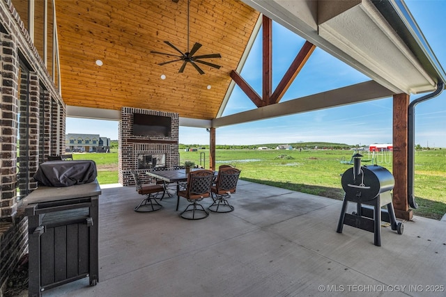 5393 W 184th St S, Mounds, OK 74047 - view of patio with a grill, ceiling fan, outdoor dining space, and an outdoor brick fireplace