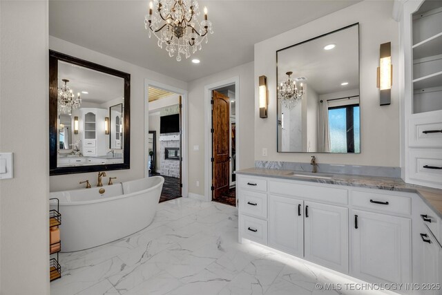5393 W 184th St S, Mounds, OK 74047 - bathroom with recessed lighting, a freestanding bath, a notable chandelier, and vanity