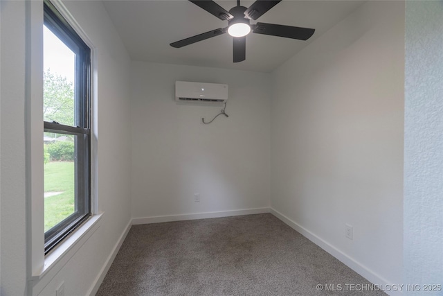 empty room with carpet flooring, a ceiling fan, baseboards, and a wall mounted AC