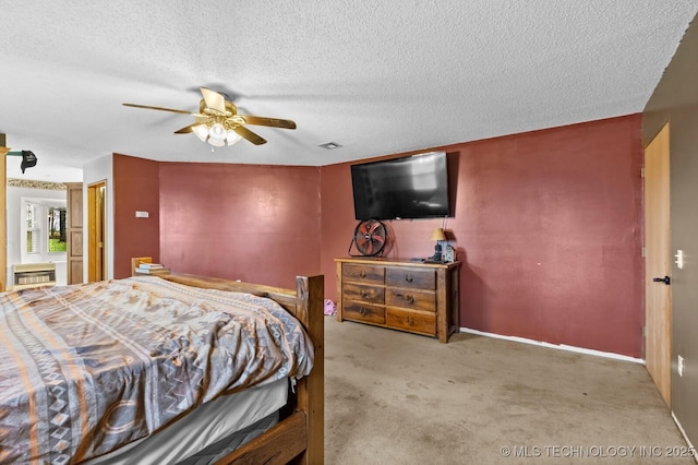 bedroom with a textured ceiling, carpet flooring, a ceiling fan, and baseboards