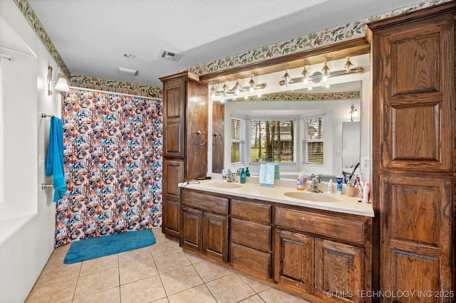 full bathroom featuring tile patterned floors, double vanity, a shower with shower curtain, a sink, and visible vents