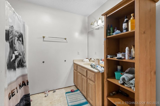 full bath with a textured ceiling, a shower with curtain, and vanity
