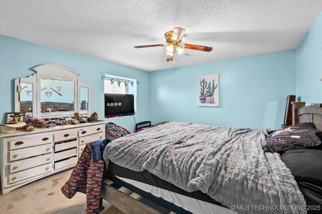bedroom with a textured ceiling, a ceiling fan, and carpet floors
