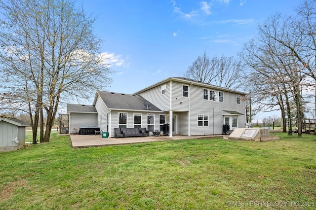 rear view of property featuring outdoor lounge area, a yard, and a patio area