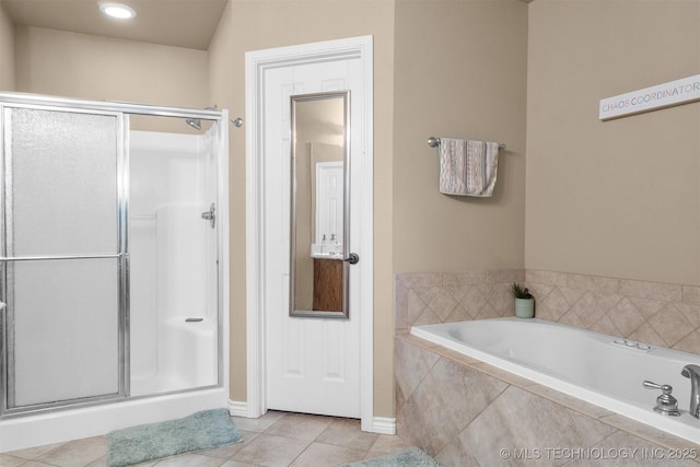 1516 Kay St, Durant, OK 74701 - bathroom featuring a bath, tile patterned flooring, a shower stall, and baseboards