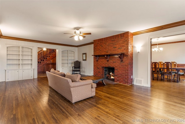 3855 S Utica Ave, Tulsa, OK 74105 - living area with stairway, wood finished floors, a brick fireplace, crown molding, and built in features