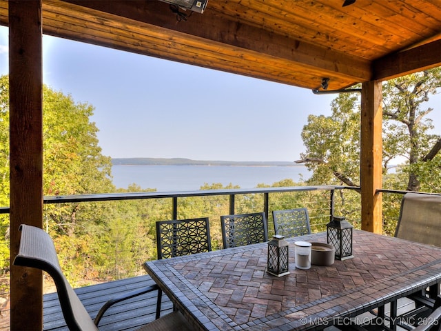 exterior space featuring a patio area, a water view, and outdoor dining area