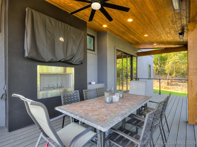 deck featuring outdoor dining area and ceiling fan
