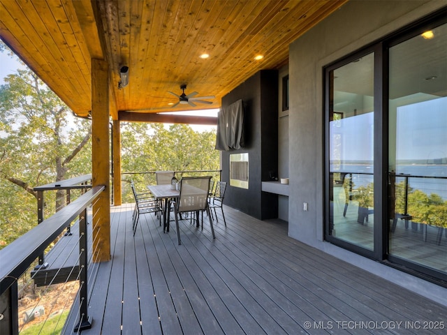 deck featuring outdoor dining area and a ceiling fan