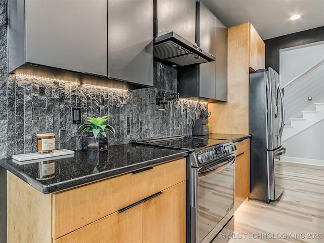 kitchen with stainless steel fridge, dark stone countertops, black range with electric stovetop, tasteful backsplash, and light wood-style flooring