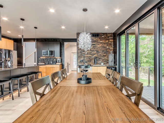 dining room with a chandelier, recessed lighting, and a wealth of natural light