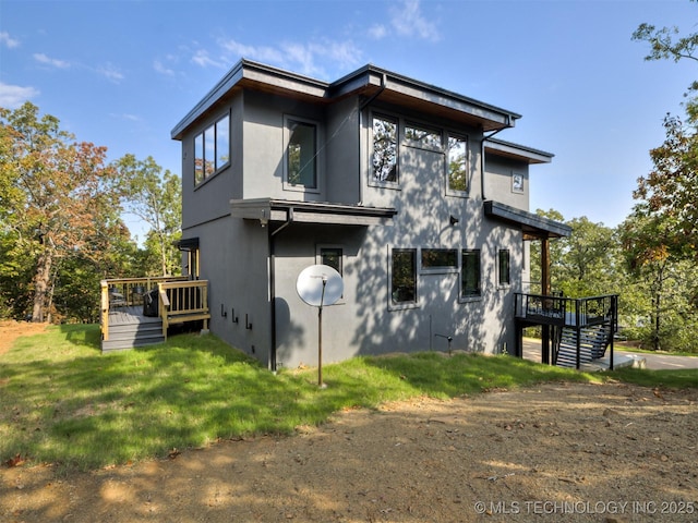 exterior space with stairway, a deck, and a yard