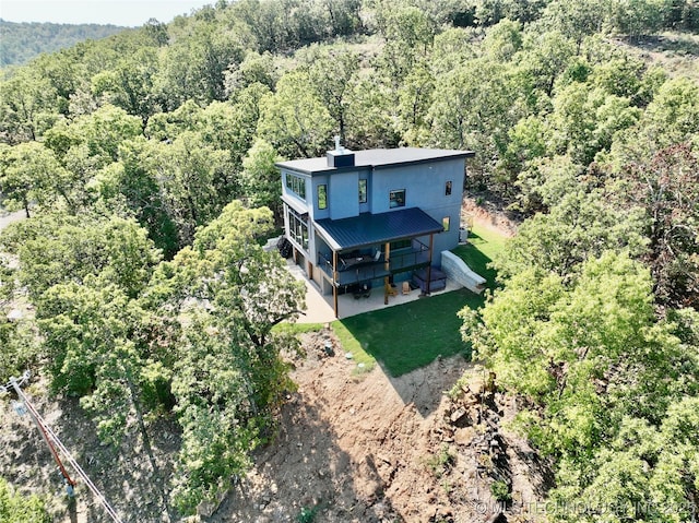 birds eye view of property featuring a view of trees