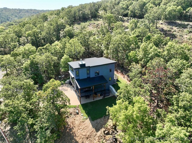 birds eye view of property with a view of trees