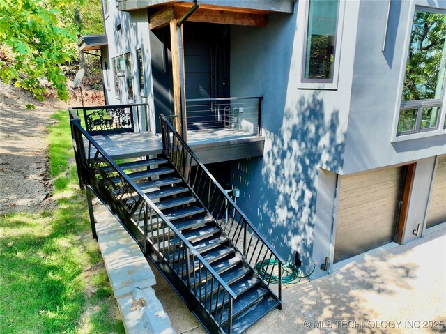 entrance to property featuring stucco siding