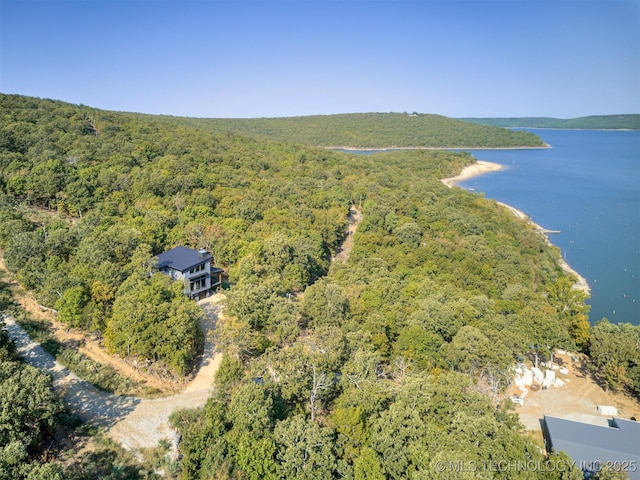 aerial view featuring a water view and a forest view