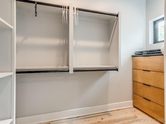walk in closet featuring light wood-style floors