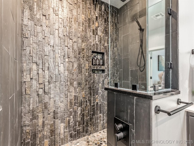 full bathroom featuring walk in shower and visible vents