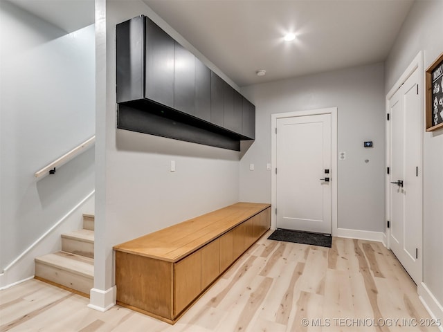 mudroom featuring baseboards and light wood-style floors