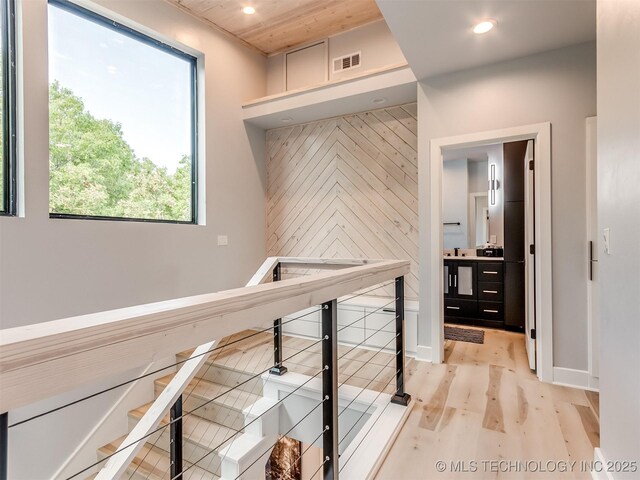 hall with visible vents, light wood-style flooring, and recessed lighting