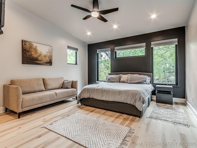 bedroom featuring baseboards, light wood-type flooring, lofted ceiling, and recessed lighting