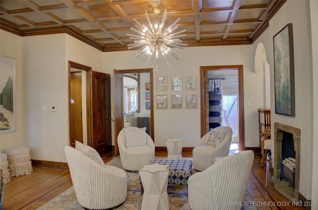 2156 S Owasso Pl, Tulsa, OK 74114 - living area featuring arched walkways, coffered ceiling, and wood finished floors