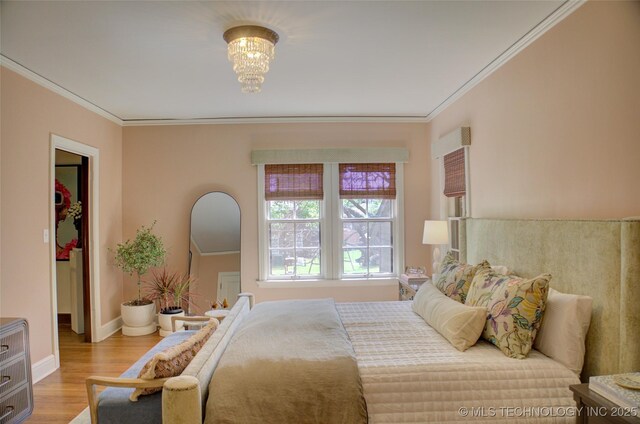 2156 S Owasso Pl, Tulsa, OK 74114 - bedroom featuring ornamental molding, a walk in closet, and wood finished floors
