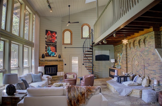 2156 S Owasso Pl, Tulsa, OK 74114 - living area featuring track lighting, stairs, a fireplace, and high vaulted ceiling