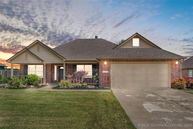 view of front of house with an attached garage, a shingled roof, and brick siding